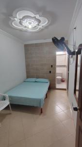 a bedroom with a blue bed in a room at Hotel Real Caracoli in Guamal