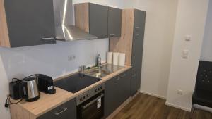 a small kitchen with a sink and a stove at Spacious Apartment for 8 Guests in Tuttlingen