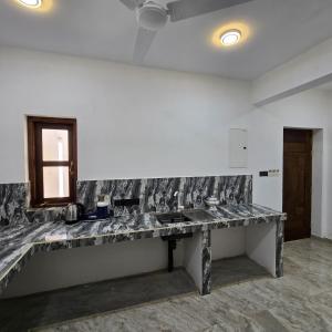 a marble counter in a room with a window at Waypoint Resort and Apartments in Hikkaduwa