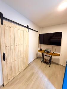 a room with a sliding barn door and a desk at Hotel Casa Oliveros in Rivera