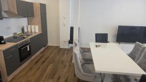 a kitchen with a white table and a counter top at Spacious Apartment for 8 Guests in Tuttlingen +8 photos