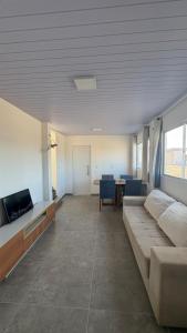a large living room with a couch and a tv at Maramarbh43 in Luis Correia