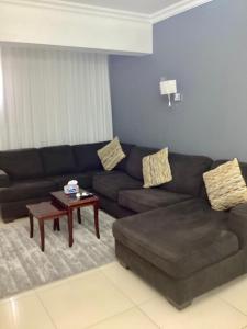 a living room with a couch and a coffee table at Compound Porto New Cairo in Cairo