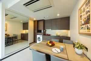 a kitchen and dining room with a table and chairs at LiT BANGKOK Residence in Bangkok