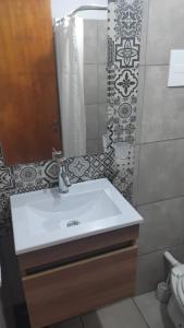 a bathroom with a white sink and a mirror at Kallpa in Santa Rosa +9 photos
