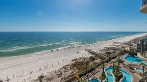 a view of the beach from the balcony of a resort at Phoenix West 708 in Orange Beach
