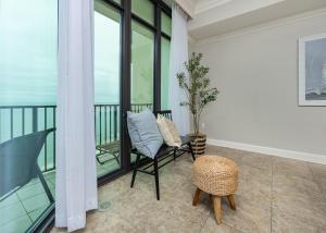 a balcony with a chair and a table at Phoenix West 2008 in Orange Beach