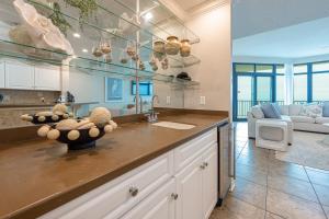 a kitchen with a counter top and a living room at Phoenix West 2008 in Orange Beach +44 photos