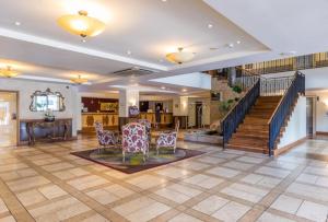 a living room with chairs and stairs in a house at Sky Tower Studio - Pools, Spa, Gym & Super King in Auckland +17 photos