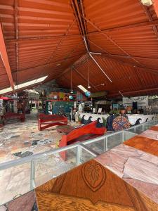 a large room with couches and tables in a building at Rocking J's in Puerto Viejo