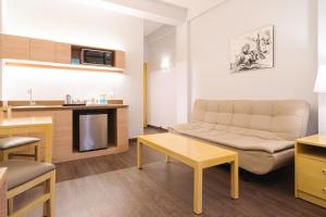a living room with a couch and a table at Microtel by Wyndham Batangas in Santo Tomas