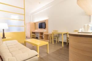 a living room with a couch and a table at Microtel by Wyndham Batangas in Santo Tomas