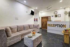 a living room with a couch and a television at Hotel Ashram View With Luxury Near Nizamuddin Railway Station in New Delhi