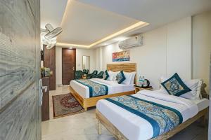 a hotel room with two beds and a corridor at Hotel Ashram View With Luxury Near Nizamuddin Railway Station in New Delhi +92 photos