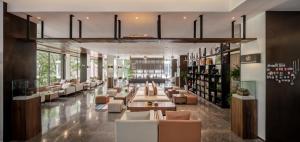 a lobby with couches and tables in a building at Between Trees and Streams in Jiuzhaigou