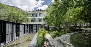 an exterior view of a house with a garden at Between Trees and Streams in Jiuzhaigou