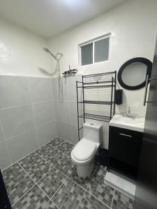 a bathroom with a white toilet and a sink at Casa Rayon Oaxaca in Oaxaca City