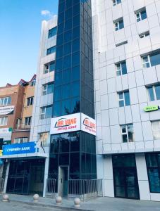 a tall building with a sign on it at Och Service Apartment in Ulaanbaatar