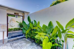 a building with a buddha mural on the wall at Olala Suite Canggu Guesthouse in Canggu
