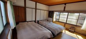 a large bed in a room with a window at Suzume no oyado SO1 in Shima +43 photos