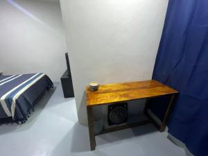 a bedroom with a bed and a wooden table at Casa Rayon Oaxaca in Oaxaca City