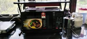 a microwave with a picture of a bowl of food at Lakefront Homestay in Taiping