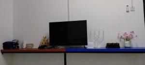 a television sitting on top of a blue table at Lakefront Homestay in Taiping