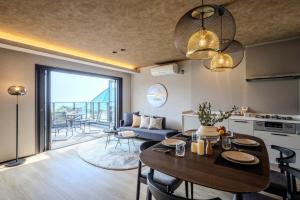 a kitchen and living room with a table and a dining room at KomoreNest伊豆熱川 in Higashiizu
