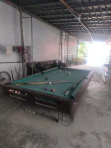a garage with a pool table in a room at Rjoyz transient house in Itogon