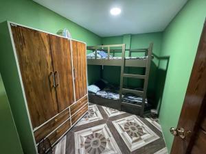 a room with two bunk beds and a door at Rjoyz transient house in Itogon