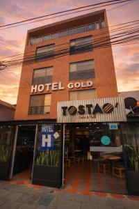 a hotel building with a hotel gold sign on it at Hotel Dorado Gold in Bogotá
