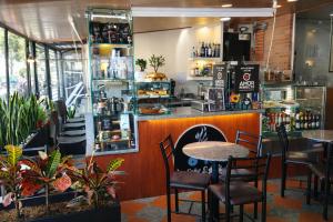 a restaurant with a table and chairs and a counter at Hotel Dorado Gold in Bogotá