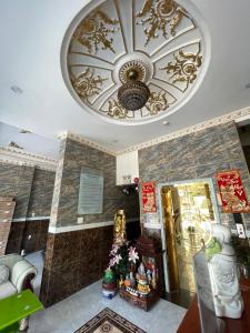 a room with a ceiling with a chandelier at King hotel in Dĩ An