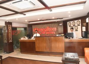 a restaurant with two men sitting at a counter at Royalton Hotel Rawalpindi in Rawalpindi