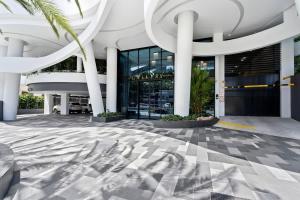 a lobby of a building with a palm tree at The Gallery Broadbeach - Hosted by Gold Coast Luxury Resorts in Gold Coast