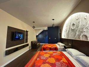 a bedroom with a large bed and a tv at Casa Lolita in San Juan La Laguna