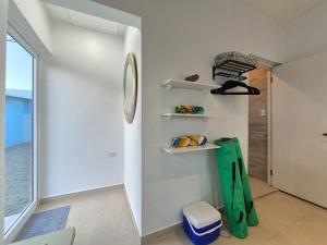 a bathroom with white walls and shelves and a window at Villa Sirena Azul Apt 1 in Palm-Eagle Beach +10 photos