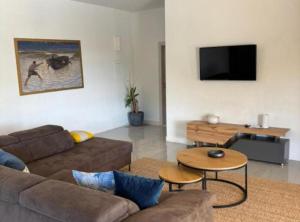 a living room with a couch and a table at Villa Coral in Novo Selo