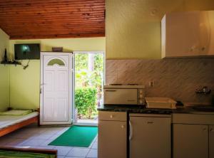 a kitchen with a door leading to a patio at Nirvana Apartments & Auto Camp in Kumbor +17 photos