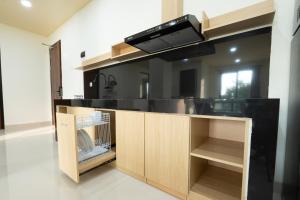 a kitchen with a counter with a sink and a microwave at Green Hill Service Apartment in Labuan Bajo