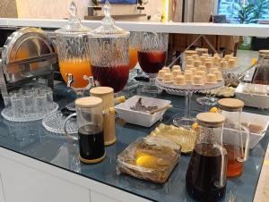 a counter with many different types of drinks in glass jars at Dostlar Hotel in Mersin