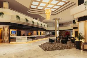 a lobby of a hotel with chairs and tables at Impiana Hotel Ipoh in Ipoh +71 photos