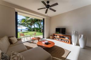a living room with a couch and a table at EEB TI KAAN TULUM - Luxury Oceanfront Residences in Tulum