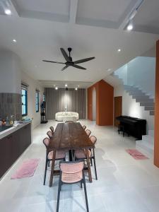 a dining room with a table and a ceiling fan at ACIS SmartHome NovaWorld in Bình Tú