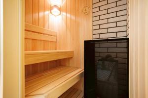 a sauna with wooden shelves and a light on the wall at Kiyomizu Elite Terrace in Kyoto