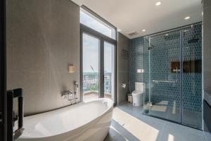 a large bathroom with a tub and a shower at AviCasa T21 in Gò Công +67 photos