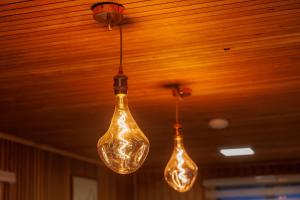 three light bulbs hanging from a ceiling at Hostal Royal Austral in Coihaique +109 photos
