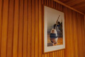 a framed picture of a vase on a wall at Hostal Royal Austral in Coihaique