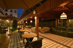 a patio with a table and chairs and a tableasteryasteryasteryasteryasteryastery at Mercure Tashkent North in Tashkent