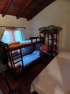 a room with two bunk beds and a bed at CHALET económico cerca del Mar in Costa Azul
